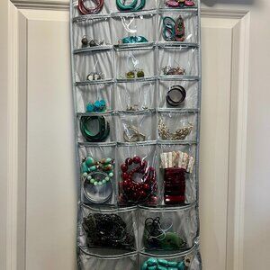Two Sided Jewelry Holder Includes Items in Pouches